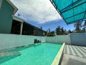 a swimming pool in the backyard of a house at Ben's House 2 in Quy Thượng