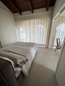 1 dormitorio con 1 cama y ventana con silla en MyVilla Suites, en Palazzo Canavese