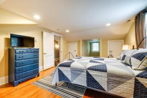 a bedroom with a bed with a blue dresser and a tv at Wilmington Vacation Rental Close to Riverwalk! in Wilmington