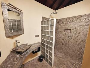 y baño con ducha y lavamanos. en Villa Mbolatsara en Nosy Be