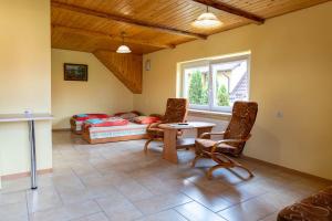 a living room with a bed and a table and chairs at Na Skraju Lasu Wilkasy in Wilkasy