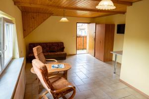 a living room with a couch and a table at Na Skraju Lasu Wilkasy in Wilkasy