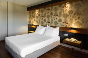 Ένα ή περισσότερα κρεβάτια σε δωμάτιο στο Hotel Lara