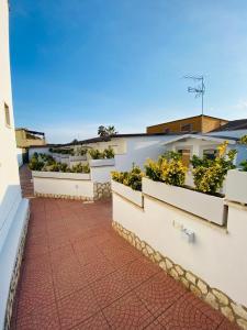 a balcony with plotted plants on the side of a building at Airport Hotel in Fiumicino