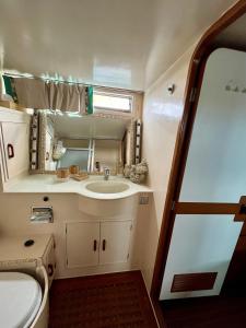 a bathroom with a sink and a mirror at Navï, yacht privé face au Mont Saint-Clair in Sète