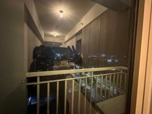 a balcony with a view of a city at Sea Residences MOA Manila by JO in Manila