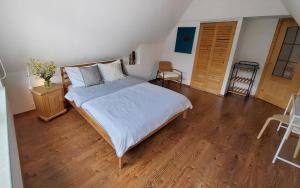 a bedroom with a large bed and a wooden floor at Ozwa SKY in Zakopane