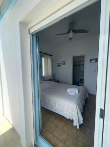 a bedroom with a bed and a large glass window at Yannis Maria Rooms in Antiparos