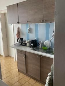 a kitchen with a sink and a counter top at Yannis Maria Rooms in Antiparos