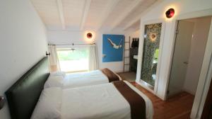 a bedroom with a large bed and a window at Villas San Roque Isla in Isla