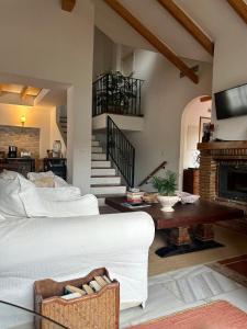 a living room with a white couch and a fireplace at At Home in Malaga Stay & Solo Travellers in Rincón de la Victoria