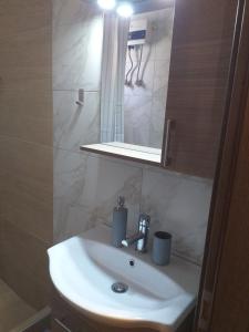 a white sink in a bathroom with a mirror at Home Sweet Home Skala Fourkas in Skála Foúrkas +21 photos