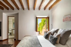 a bedroom with a bed and a large window at Can Joan Capo - Adults Only in Sineu