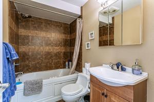 a bathroom with a sink and a toilet and a tub at Puget Sound View, Best Area, 2 Baths, 2 Bedrooms, WD, Jacuzzi Bath, New Carpet, Balcony, View, 925sf in Tacoma