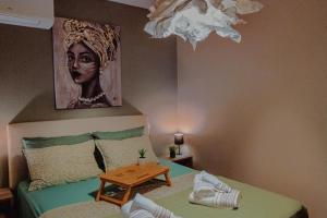 a bedroom with a bed with a portrait of a woman at Sunny Days apartment in Alexandroupoli