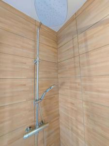 a bathroom with a shower with a wooden wall at ° Appart 3 - Lunéville centre ° in Lunéville