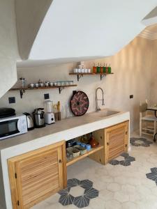 a kitchen with a sink and a counter top at Riad21 in Marrakesh