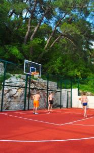 a group of people playing basketball on a court at Apartment Mediterraneo Blue Sky in Perast