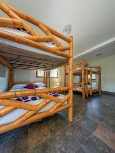 a bedroom with three bunk beds in a room at Paradise Project Hostal in Montañita