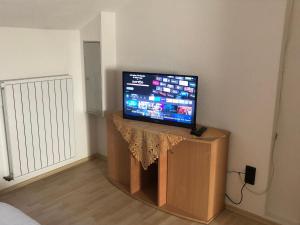 a flat screen tv sitting on a stand in a room at Ferienwohnung in Weilburg in Weilburg