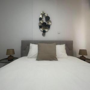 a bedroom with a large white bed with two lamps at Glamorous, Renovated 3-Bedroom Apt in Nicosia in Nicosia