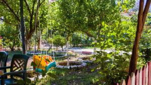 a garden with a playground with a colorful toy at BELİS APART & PANSİYON in Kemer +3 photos