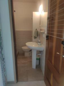 a bathroom with a white sink and a toilet at Crismela in Yaiza