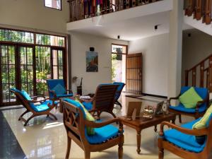 a living room with chairs and a table at A tropical paradise; stunning house, pool, garden in Wattala