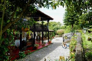 a house with a bike parked in front of it at Hotel Anacaona in San Agustín