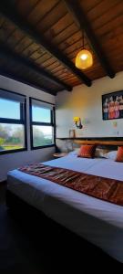 a bedroom with two large beds and two windows at Hotel Boutique Arenarena in Villa Gesell