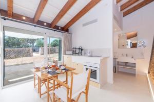 a kitchen and dining room with a table and chairs at Alcotx Country Club in Es Mercadal