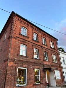 a red brick building with white doors and windows at Peipsi Teemaja in Mustvee