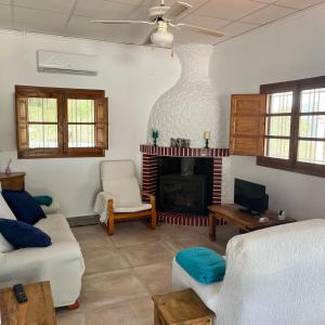 a living room with a couch and a fireplace at Villa Rios in Xàtiva