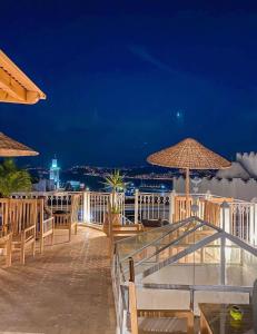 a patio with chairs and umbrellas at night at Kasba blanca in Tangier