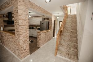 a staircase in a house with a brick wall at Pensiunea Alexandra in Miceşti