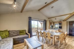 a living room with a table and chairs and a couch at Oxalis in Morillon