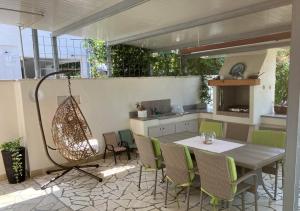 a patio with a table and chairs and a kitchen at Apartments Vlasta in Premantura
