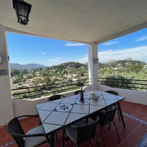 a table and chairs on a balcony with a view at Villa Rios in Xàtiva