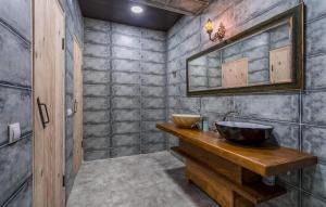 a bathroom with two sinks on a wooden counter at SVANETI in Lentekhi