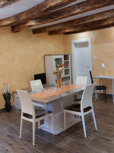 a dining room with a table and white chairs at Apartman Miljenka in Pazin