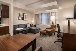 a living room with a couch and a table at Residence Inn by Marriott New York Manhattan/ Midtown Eastside in New York