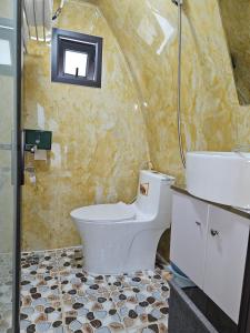 a bathroom with a toilet and a sink and a shower at Mio Hotel in Hải Dương