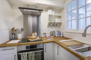 a kitchen with white cabinets and a counter top at The Garden Square - Unique luxury apartment in historic garden square - ideal for 2 people in York