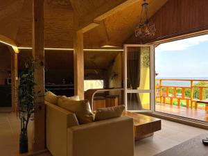 a living room with a couch and a large window at Seagull Studio Byala in Byala