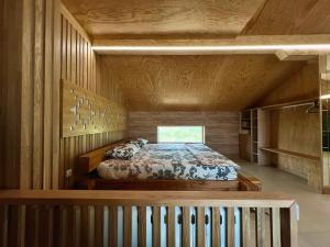 a bedroom with a bed in a room with wooden walls at Seagull Studio Byala in Byala