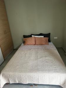 a large bed in a small room with a large mattress at Apartment GM in Neoi Epivates