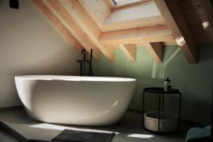 a large white bath tub in a bathroom with a ceiling at WegeLager 