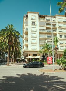 a black car parked in front of a large building at Appartement au coeur du parc de Mohammedia Haut Standing in Mohammedia