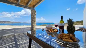 a table with a basket of bread and wine glasses at Polychronis Private Suite in Pollonia