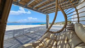 a hammock on the beach with a view of the ocean at Polychronis Private Suite in Pollonia